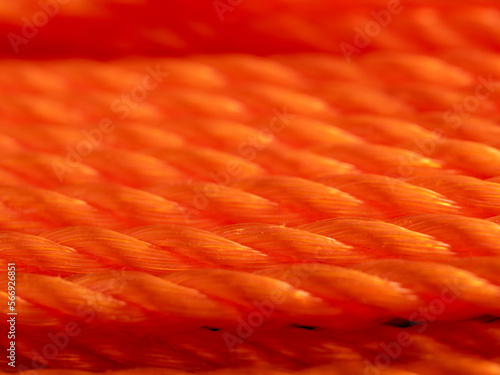 Orange rope close-up. Texture of braided rope. Orange background.