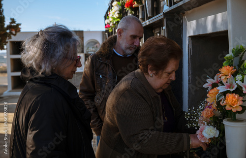 Group of family, mother, son and daughter mourning in cemetery