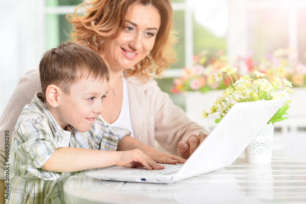 nice mother and son using modern laptop nice mother and son using modern laptop