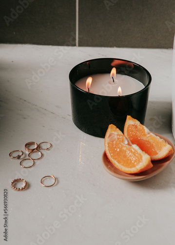 Black candle in a bathroom with jewelry, add your own logo or a text on a candle, mockup file