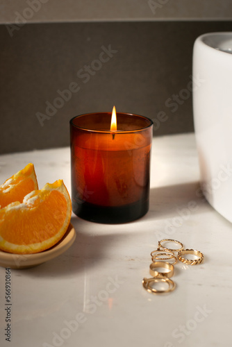 Brown Candle with the jewelry in a bathroom, add your own logo or a text, mockup file 