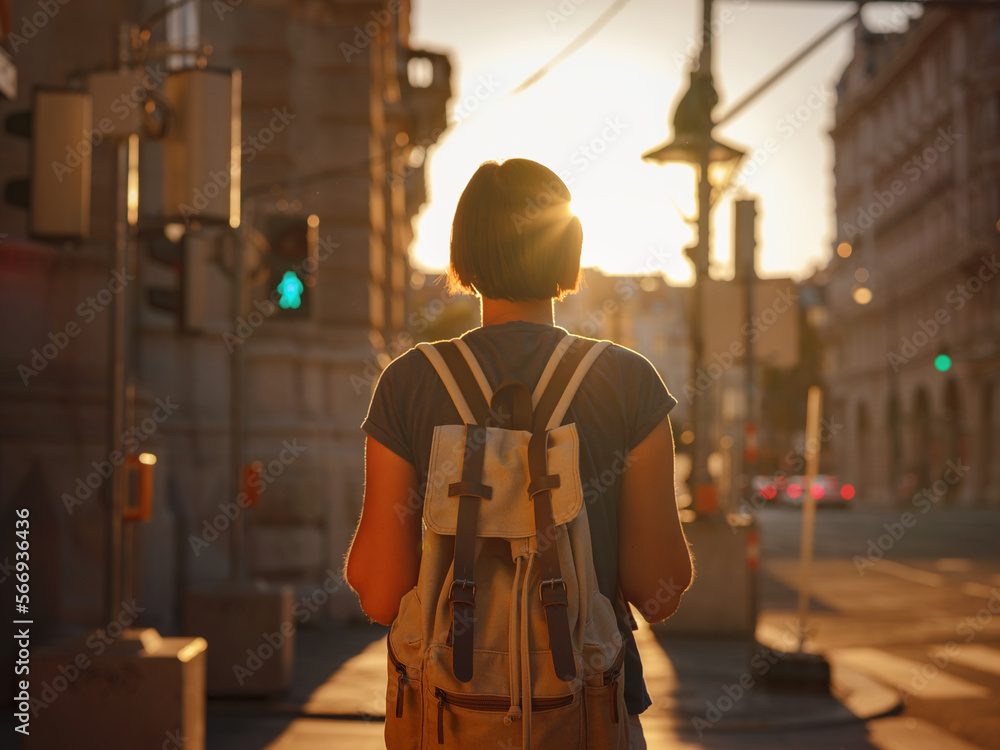 summer female solo trip to Europe, happy young woman walking on european street at sunset time. Vienna, Austria summer female solo trip to Europe, happy young woman walking on european street at sunset time. Vienna, Austria