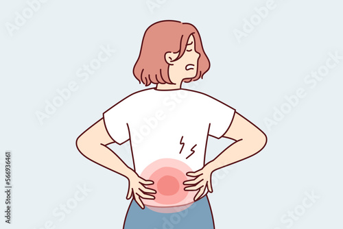 Woman stands with back to screen and holds on to red lower back after failing to lift heavy bag. Girl suffers from pain in spine needs massage or help of osteopath doctor. Flat vector illustration 