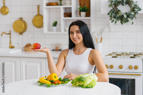 Happy healthy woman holds a peach fruit in the palm of her hand  choosing healthy food