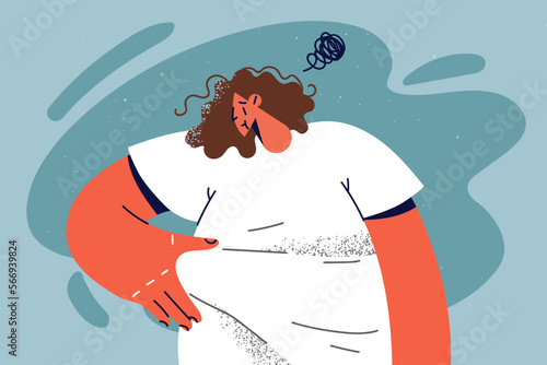 Unhappy overweight woman touch fat on belly