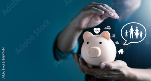Man Hand putting coin on piggy bank with virtual family icons