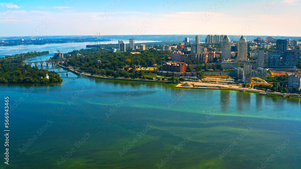 Beautiful urban environment on a summer day.  Aerial view of the summer landscape with a view of the river and the city on the shore.