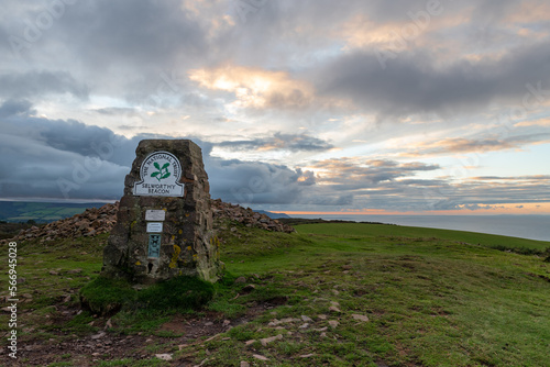 Trig point at Selworthy Beacon on North Hill, Exmoor at sunset