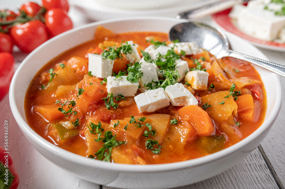 Vegetable soup with cabbage and feta cheese topping on a plate. Vegetable soup with cabbage and feta cheese topping on a plate.