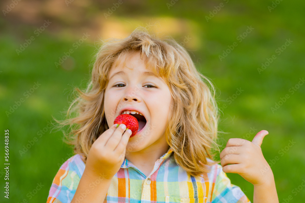Strawberry fot kids. Happy kid eating ripe, sweet, juicy, fresh strawberry. Child holding strawberries. Concept of healthy summer berries strawberries. Strawberry fot kids. Happy kid eating ripe, sweet, juicy, fresh strawberry. Child holding strawberries. Concept of healthy summer berries strawberries.