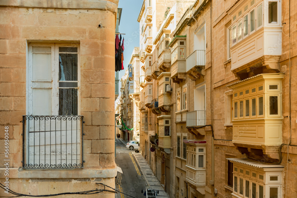 Colorful traditional Maltese balconies in Valletta. Street at sunny day