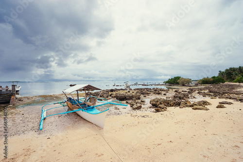 Beach with traditional fishing boat. Travel by Philippines.