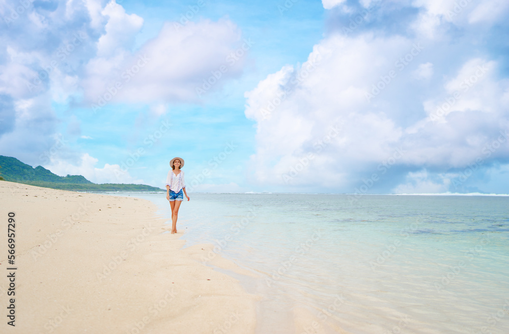 Vacation on the seashore. Young woman walking on the beautiful tropical white sand beach. Vacation on the seashore. Young woman walking on the beautiful tropical white sand beach.