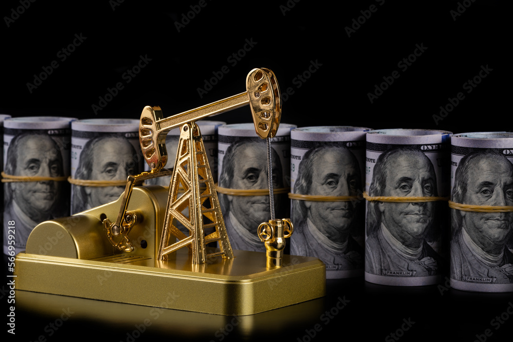 Gold oil pump model and rolled up 100 american dollar bills
Gold oil pump model and rolled up 100 american dollar bills