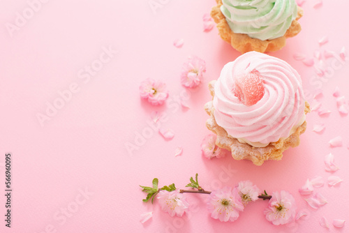 pink and green cupcakes with spring flowers on pink background