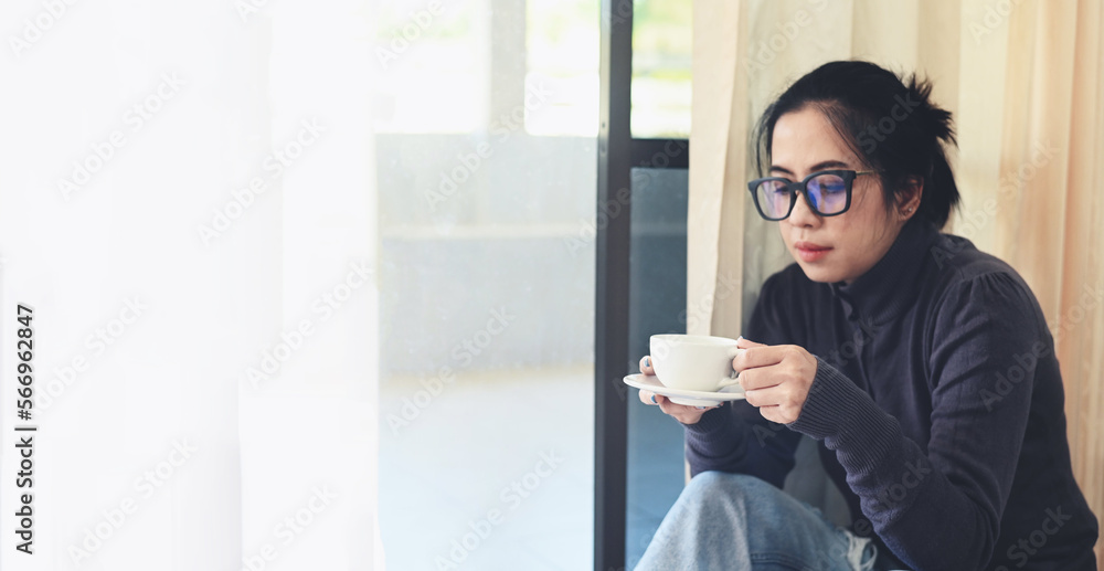 Woman relaxing at home and sitting and looking drinking coffee , Morning relaxation girl sitting and enjoying coffee leisure time happy woman relaxing in home on winter Woman relaxing at home and sitting and looking drinking coffee , Morning relaxation girl sitting and enjoying coffee leisure time happy woman relaxing in home on winter