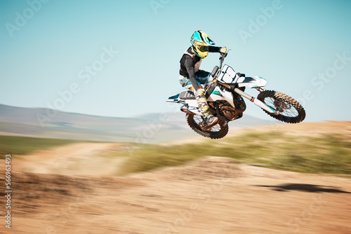 Fototapeta Naklejka Na Ścianę i Meble -  Motorcross, air jump and offroad sports with motion blur, speed challenge or desert. Driver, cycling and stunt on dirt track, competition and motorbike performance on adventure course for fast action