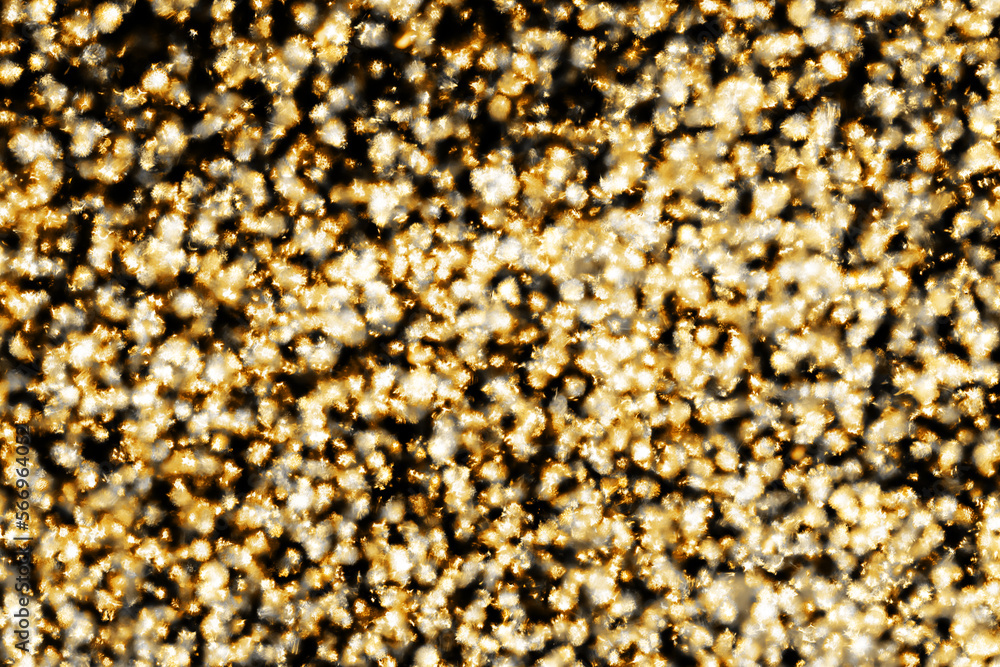 Golden shiny background. Abstract vibrant color glowing white spots texture for graphic design. Bright yellow defocused glitter texture. Festive background. Party texture. Golden shiny background. Abstract vibrant color glowing white spots texture for graphic design. Bright yellow defocused glitter texture. Festive background. Party texture.