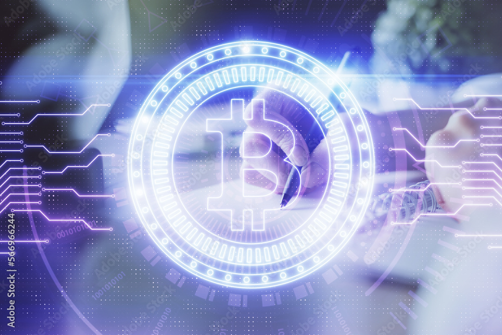Cryptocurrency hologram, bitcoin, ico theme over hands taking notes background. Concept of blockchain. Multi exposure Cryptocurrency hologram, bitcoin, ico theme over hands taking notes background. Concept of blockchain. Multi exposure