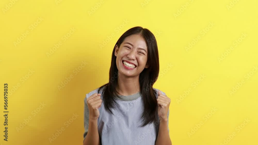 Woman posing extremely happy to win, Successful, Show extreme happiness, Very happy, yes, Lonely woman on yellow background. Woman posing extremely happy to win, Successful, Show extreme happiness, Very happy, yes, Lonely woman on yellow background.
