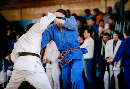 male judoists wrestling in judo competition