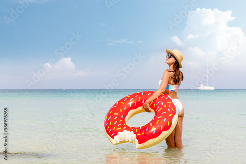 Beautiful woman with inflatable donut