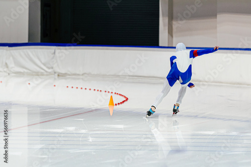 back speed skater athlete to run in ice skating photo