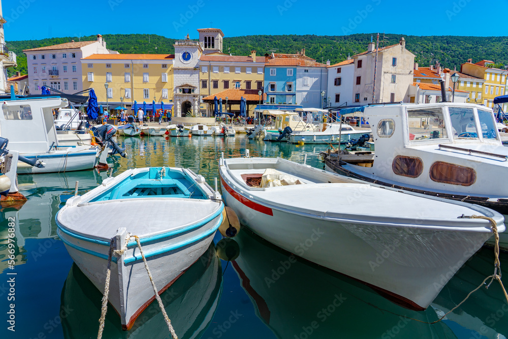 Boats and Colorful houses of Cres old town bay harbor and the hour tower