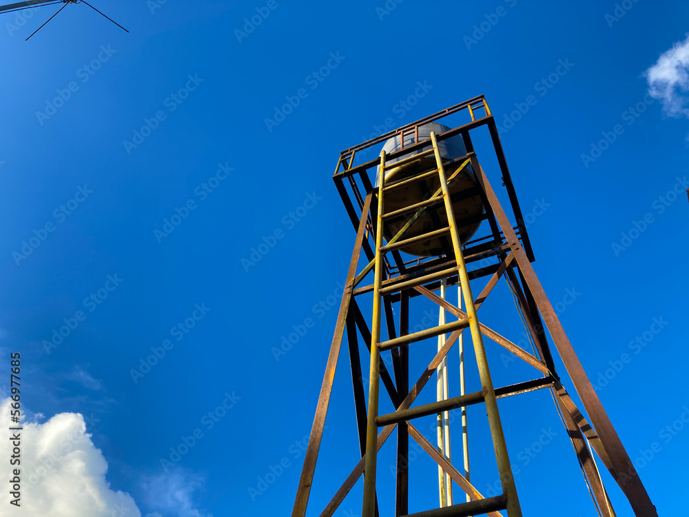 old water tank with clear blue sky background
