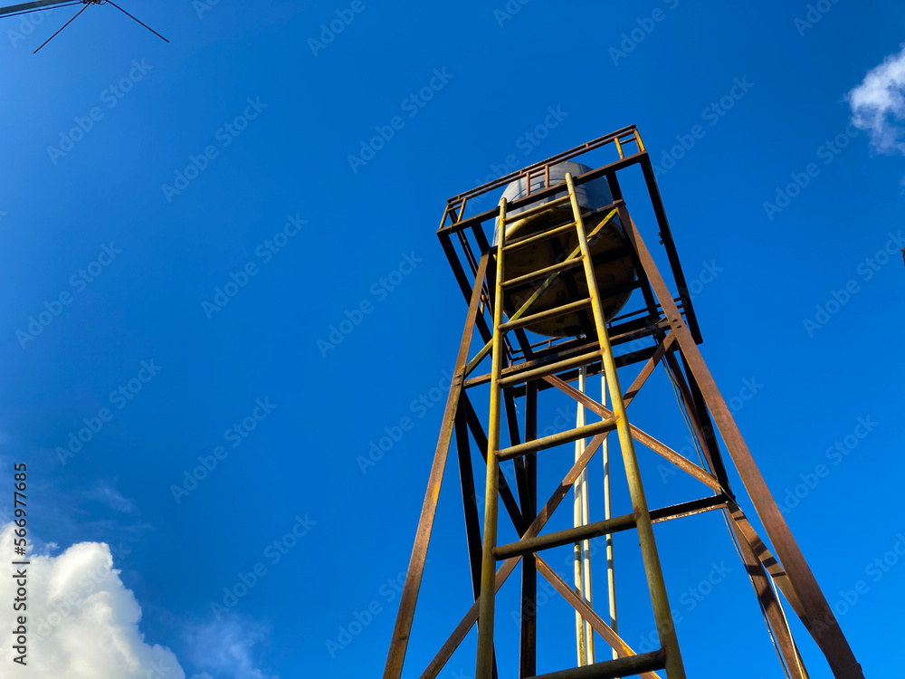 old water tank with clear blue sky background