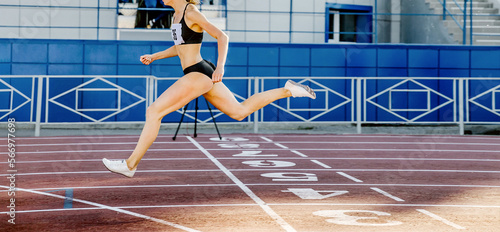 girl leader athlete run at finish line track and field competition photo