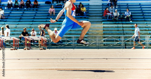 male athlete triple jump track and field competition photo