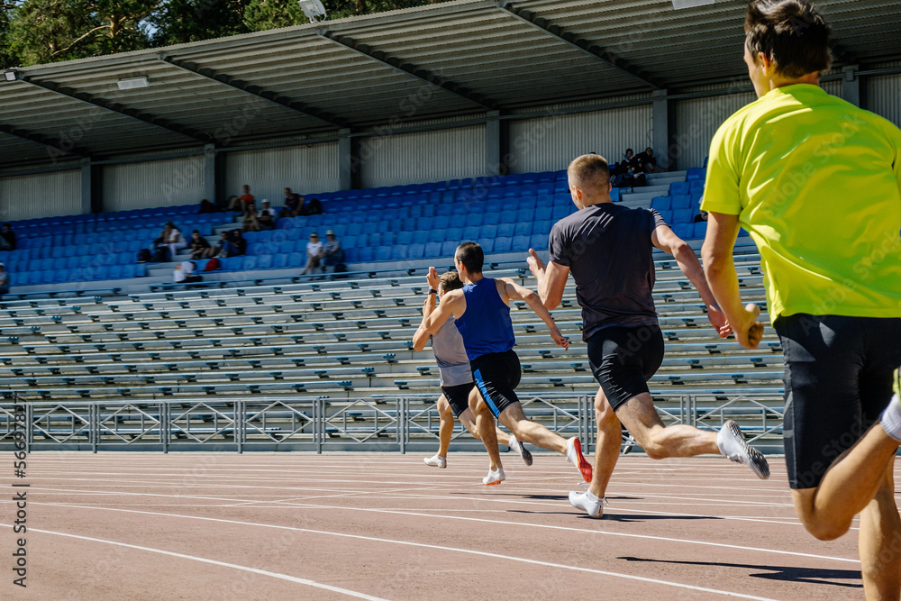 group male athletes run sprint race at competition