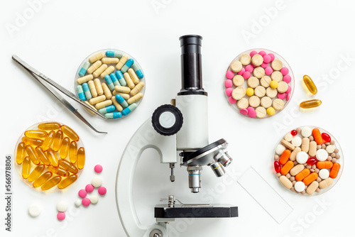 Nutritional science concept with medical drugs and microscope in the lab