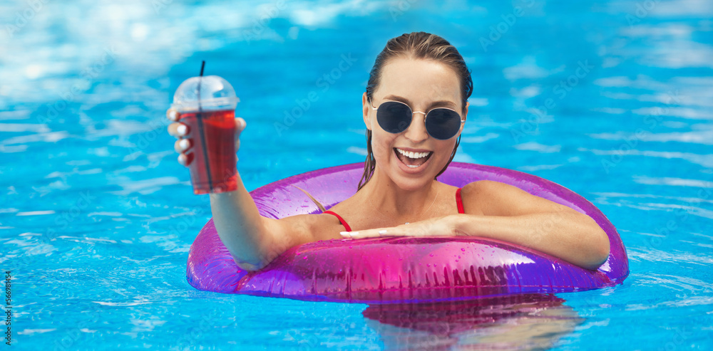 Emotional portrait of a young and beautiful girl feels happiness, swims in the pool in an inflatable swimming circle on vacation