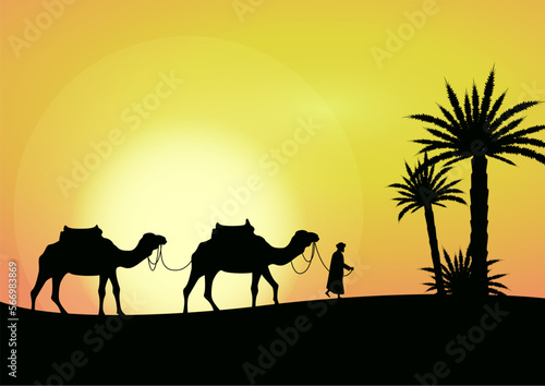 camel caravan going through the desert and palm trees on beautiful sunset background