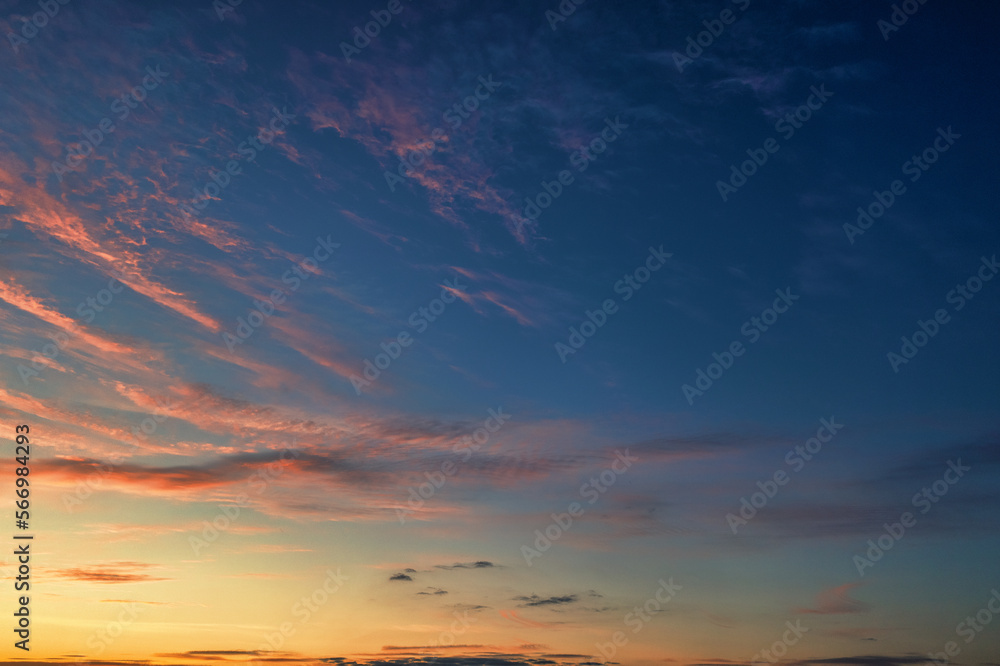 Fototapeta premium The sky before dawn, orange clouds on the background of the blue sky.