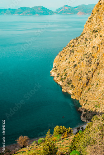 Fototapeta Naklejka Na Ścianę i Meble -  Top view of clear beach and transparent sea of Butterfly Valley. one of the most beautiful beaches in Turkey.