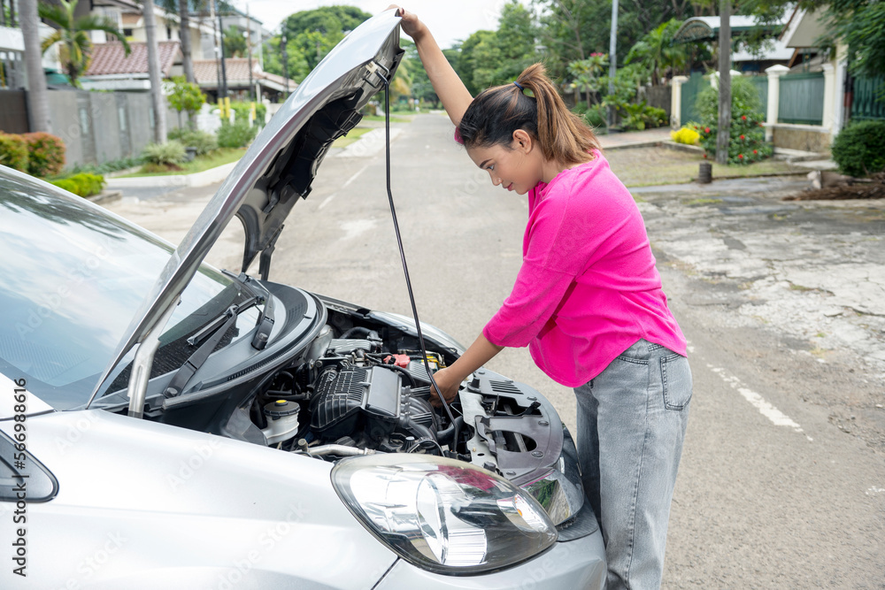 Asian woman opening car hood and looking for trouble car breaks down Asian woman opening car hood and looking for trouble car breaks down