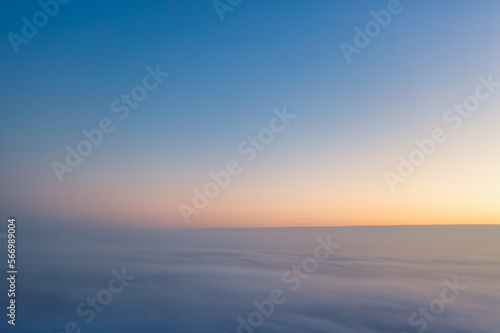 Yellow and blue dawn over clouds, concept, travel and leisure.