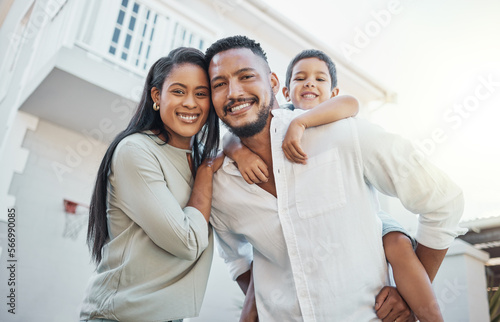 Mother, father and child with smile for new home, property or real estate family time outside the house. Portrait of happy mom, dad and son on piggyback smiling in happiness for apartment building
