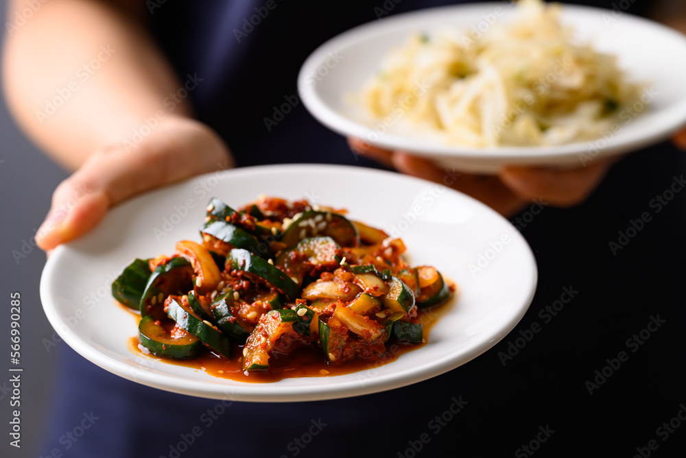 Kimchi cucumber holding by hand, Korean food side dish Kimchi cucumber holding by hand, Korean food side dish