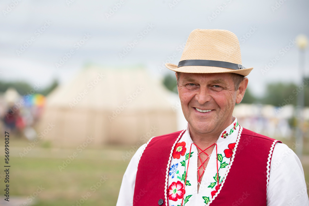 Slavic man in an ethnic Belarusian costume and a straw hat. Slavic man in an ethnic Belarusian costume and a straw hat.