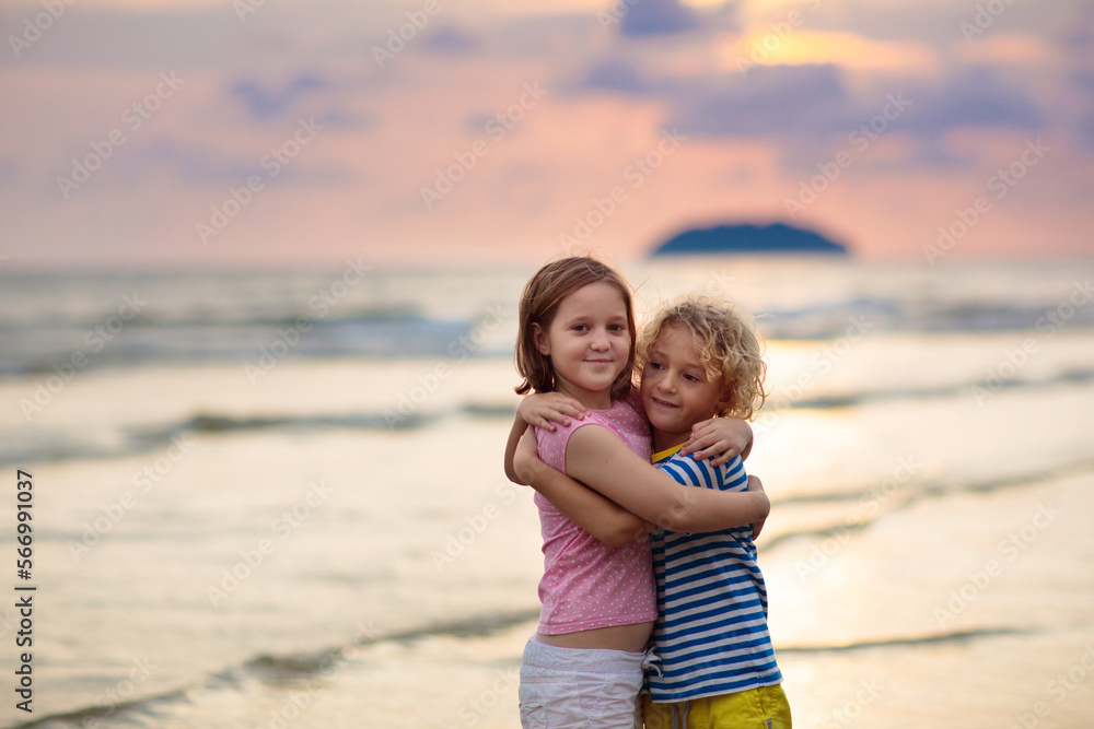 Child playing on ocean beach. Kid at sunset sea. Child playing on ocean beach. Kid at sunset sea.