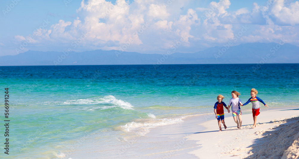 Kids playing on beach. Children play at sea.