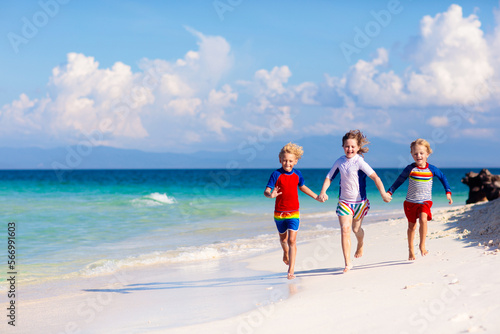 Kids playing on beach. Children play at sea. © famveldman