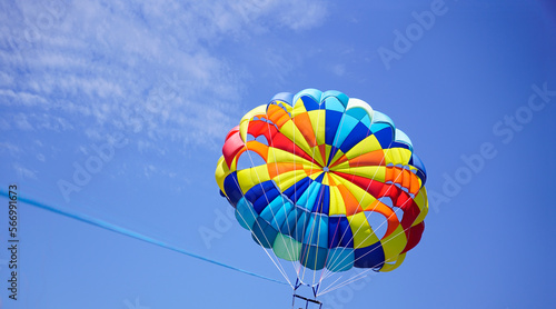 Beautiful parasailing balloon in the background of clear blue sky photo