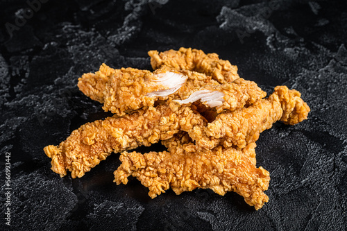 Breaded chicken strips  Fingers, breaded breast meat. Black background. Top view photo