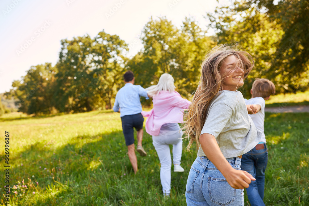 Happy family in motion on a meadow Happy family in motion on a meadow