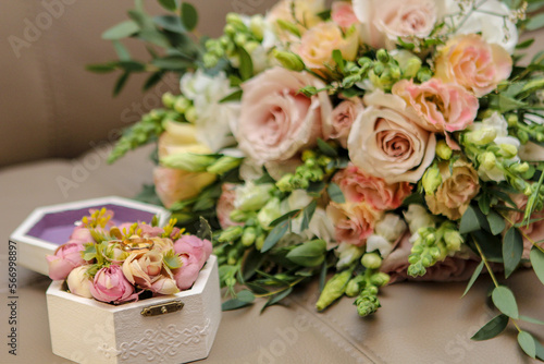 Wedding photography. Photo of a bouquet of flowers and a ring. Wedding rings in a box. Flowers. Wedding. A bouquet of flowers.